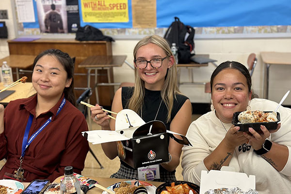 group of smiling people holding food