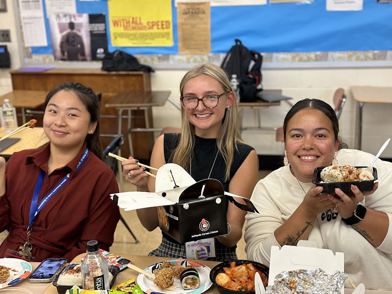 Smiling people holding food